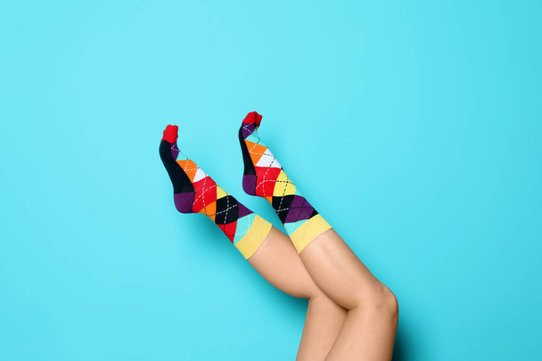 Woman wearing bright socks on color background - Photo, image
