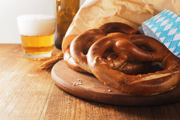 Salted pretzels for Oktoberfest on old  wooden board  with free text space. - 写真・画像