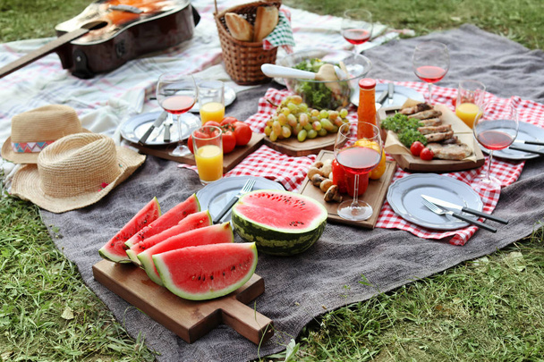 Blanket with food prepared for summer picnic outdoors - Foto, Imagen