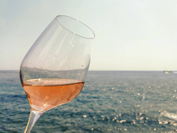 Copo de vinho rosa no litoral da Riviera Francesa
 - Foto, Imagem