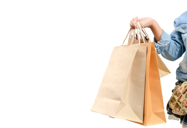 KId hand holding Brown paper shopping bag with white background, shopping concept - Photo, Image