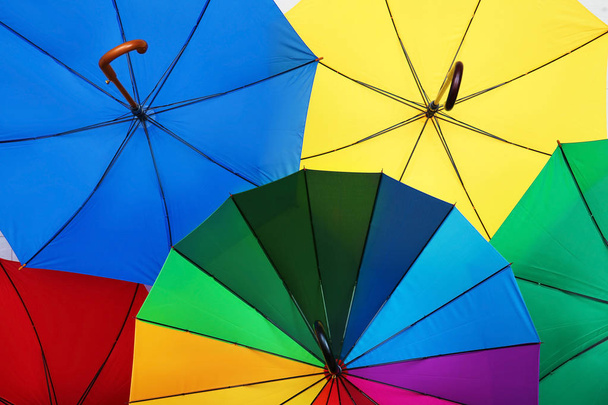 Many stylish colorful umbrellas as background, closeup - Fotó, kép
