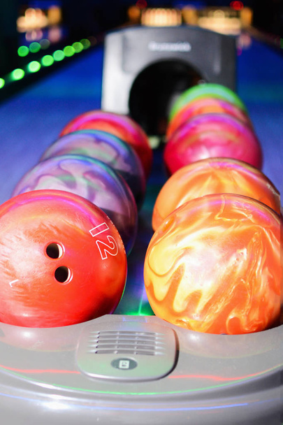 Close up of row of bowling balls in hall. Bowling bowls return system - Foto, imagen