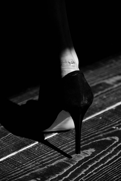 rub on leg in black fashionable shoe of glamour woman - Fotografie, Obrázek