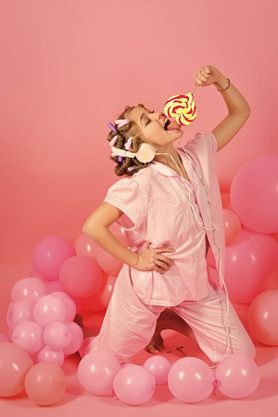 Close-up of a little Girl with a big colorful lollipop - Fotó, kép