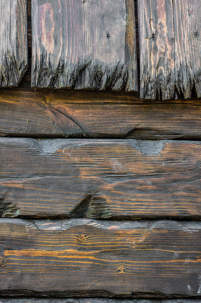 an old wall of cracked dark planks. design background - 写真・画像
