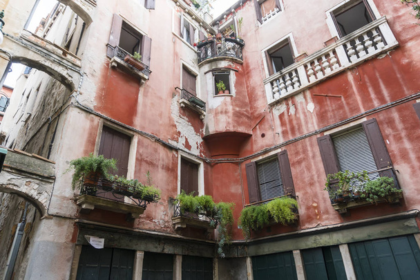 ein Haus mit schönen Balkonen und Blumen in Venedig - Foto, Bild
