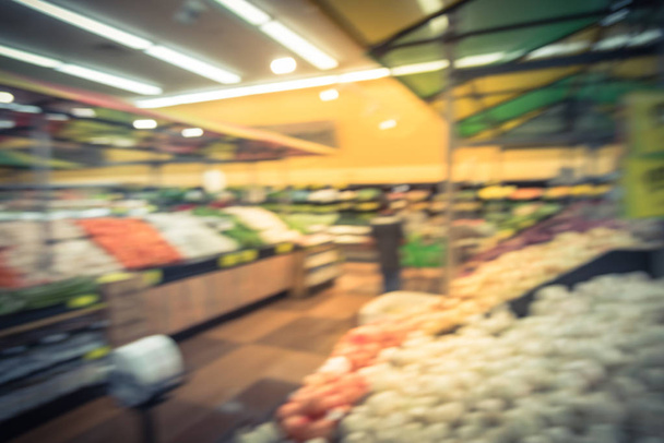 Винтажный тон размыл людей, делающих покупки в местной латиноамериканской сети супермаркетов в США. Клиент покупает свежие фрукты, овощи. Органические местные производят дисплей. Здоровое питание в продуктовом магазине
 - Фото, изображение
