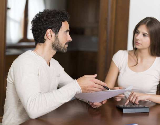 Couple having a conversation while doing accounting at home - Foto, Imagem