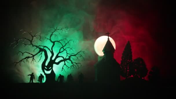 Gruseliger Blick auf Zombies auf Friedhof toter Baum, Mond, Kirche und gruselig bewölkten Himmel mit Nebel, Horror-Halloween-Konzept. gemildert - Filmmaterial, Video