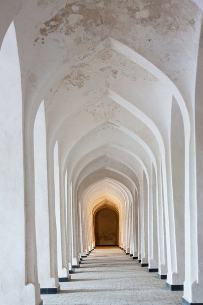 White Arabian arches in Kolon mosque. Bukhara. Uzbekistan. Central Asia. - Photo, Image