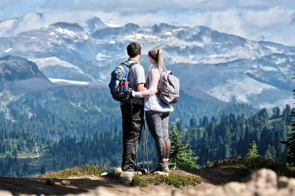Young active couple hiking in mountains in Pacific Northwest. Garibaldi Park near Vancouver. British Columbia. Canada. - Photo, Image