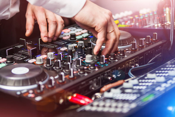 DJ playing music at control panel - Foto, Bild