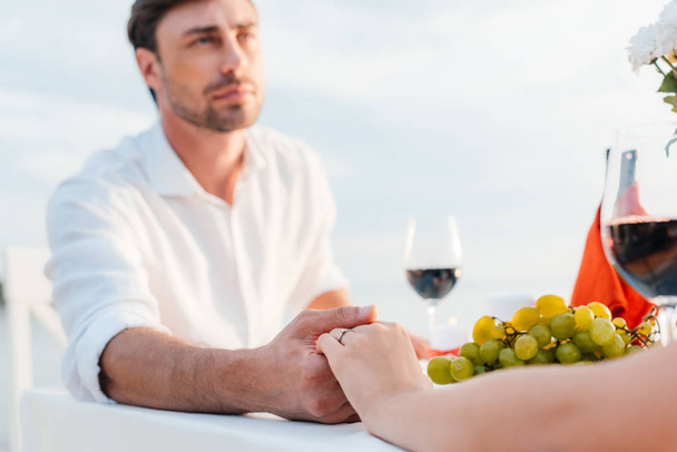 young couple holding hands after propose in romantic date - Φωτογραφία, εικόνα