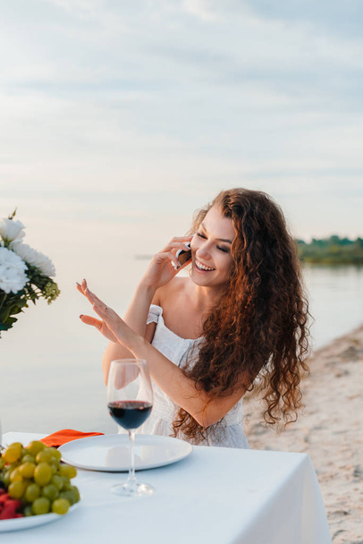 attractive happy woman talking on smartphone and looking on engagement ring on her hand - Photo, Image