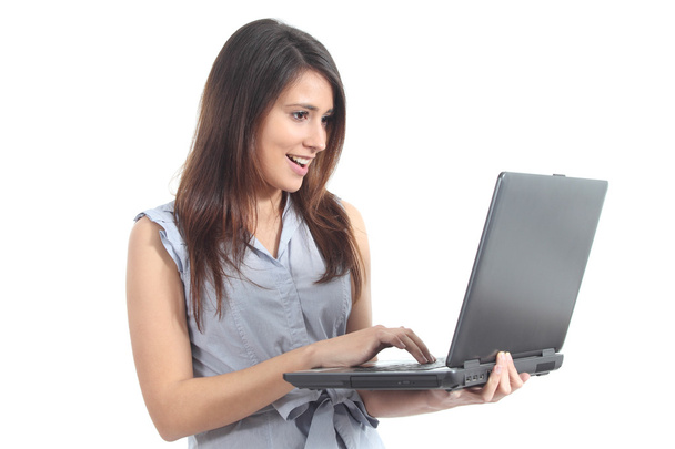 Beautiful woman standing amazed watching a laptop - Photo, image