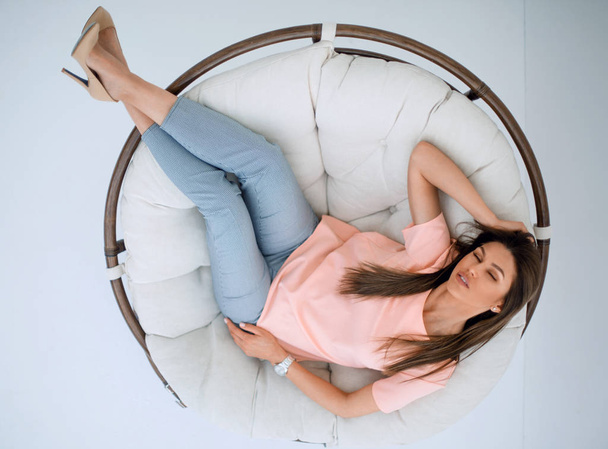 top view.young woman relaxing in a comfortable chair - Фото, зображення