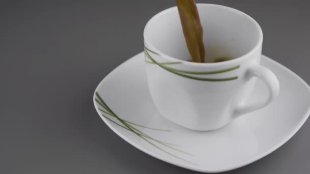 Pouring fresh made coffee into a coffee cup - Materiał filmowy, wideo