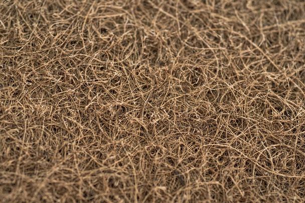 Matras met kokos vezel. Kokosnoot kokos. Geraspte Cocos schil voor de productie van matrassen. textuur, natuurlijke achtergrond. - Foto, afbeelding