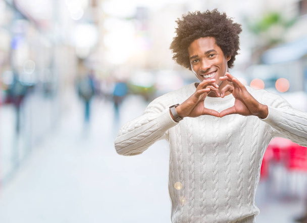 Afro american man over isolated background smiling in love showing heart symbol and shape with hands. Romantic concept. - Foto, afbeelding