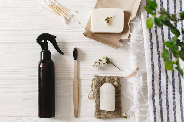 sustainable lifestyle. zero waste concept. natural eco bamboo toothbrush, coconut soap, handmade detergent, crystal deodorant, bamboo ear sticks on towel, bathroom essentials - Photo, Image