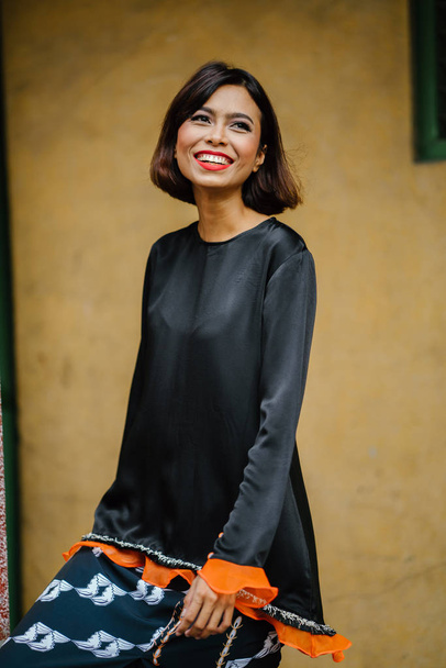 Portrait of a young, attractive and photogenic Singaporean Malay woman posing outdoors  - Foto, Imagen