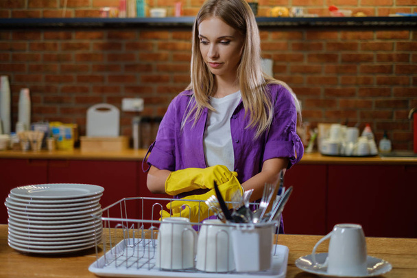Young beautiful woman works in kitchen - Photo, Image