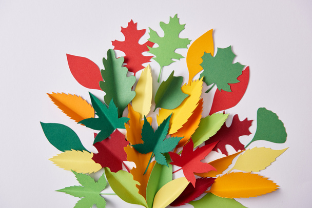 flat lay with colorful handmade paper foliage arranged on white background - Zdjęcie, obraz