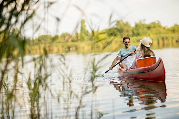Loving couple rowing on the lake at summer day - Photo, Image
