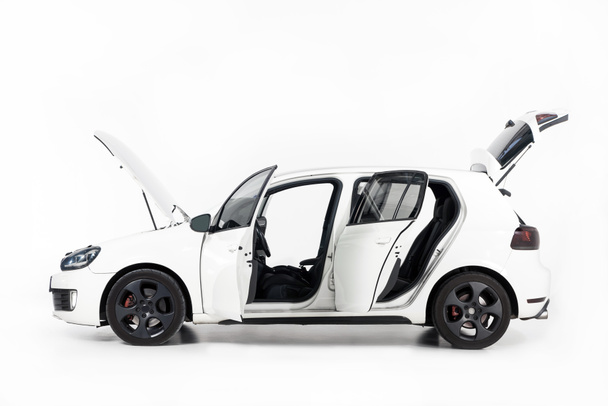 side view of new white car with open doors and open hood on white - Photo, Image