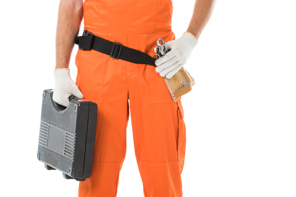 cropped image of auto mechanic in orange uniform holding toolbox isolated on white - Foto, imagen