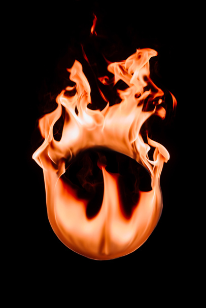 close up view of burning circle figure isolated on black - Photo, Image