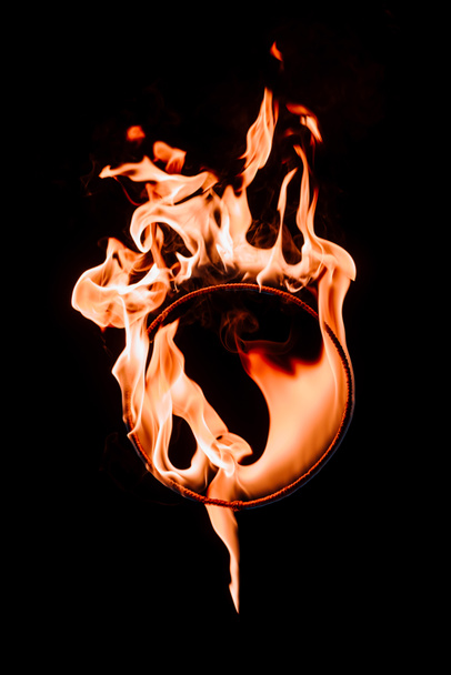 close up view of burning circle figure isolated on black - Photo, Image