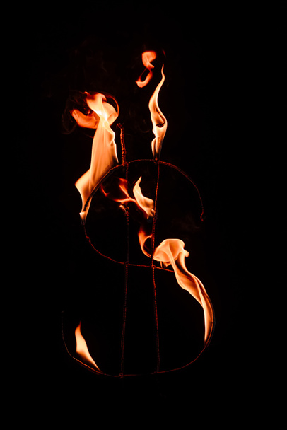 close up view of burning dollar sign isolated on black - Photo, Image
