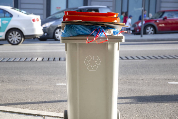 recycling bin (trash can) with garbage and recycling symbol on the street - 写真・画像