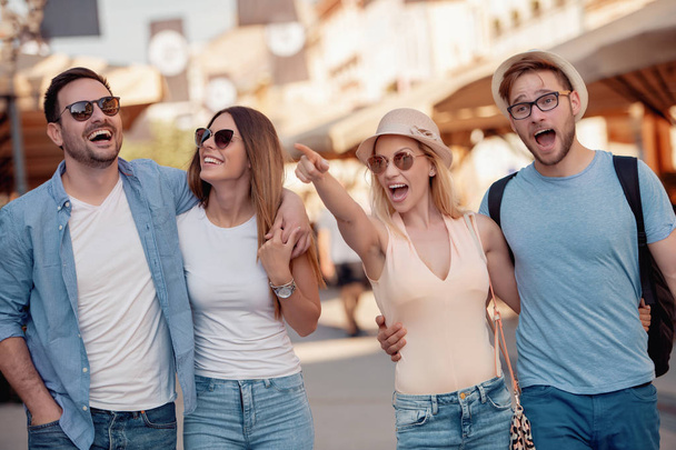 Group of tourists enjoying in the city having fun. - Fotografie, Obrázek