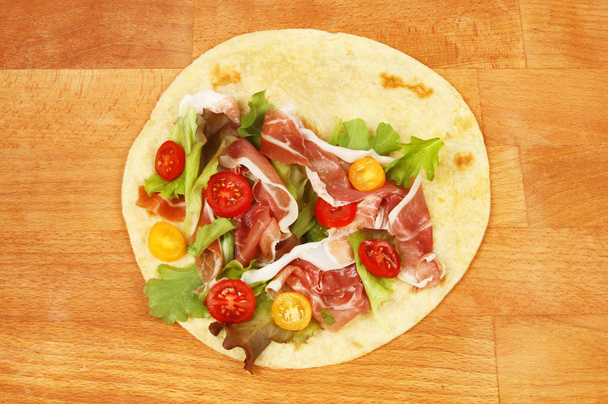 Salad and parma ham on a piada flatbread - Фото, зображення