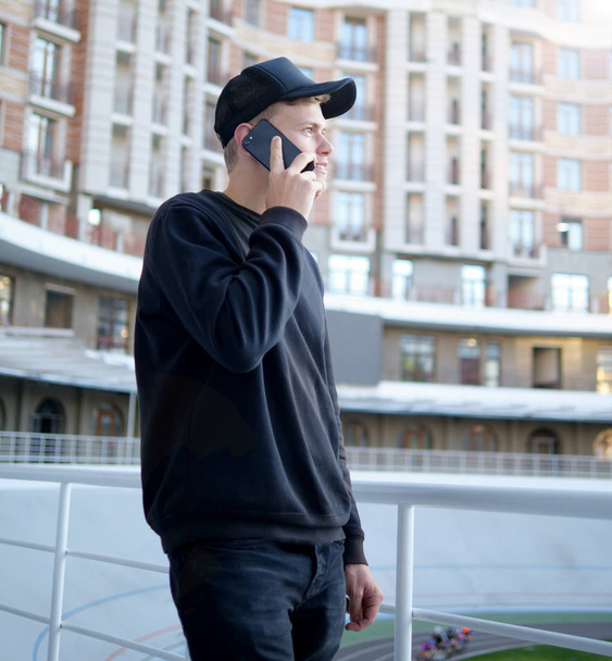 Young man talking on the phone - Fotó, kép