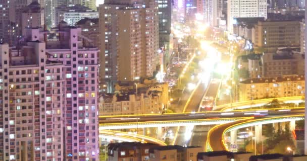 4k Timelapse of freeway busy city rush hour heavy traffic jam highway at night,Overpass interchange,the light trails of traffic with super long exposures for each frame,Brightly lit urban morden building. - Footage, Video