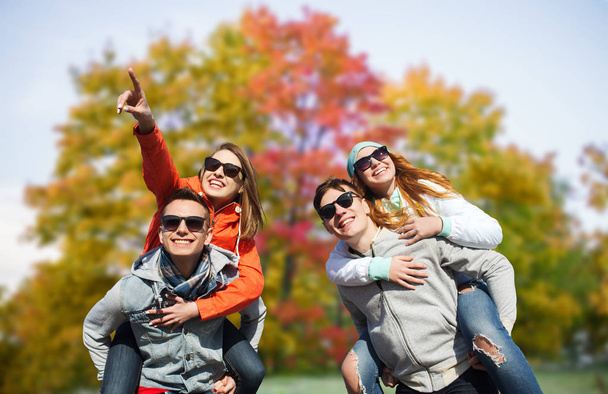 happy friends in shades having fun in autumn park - Фото, зображення