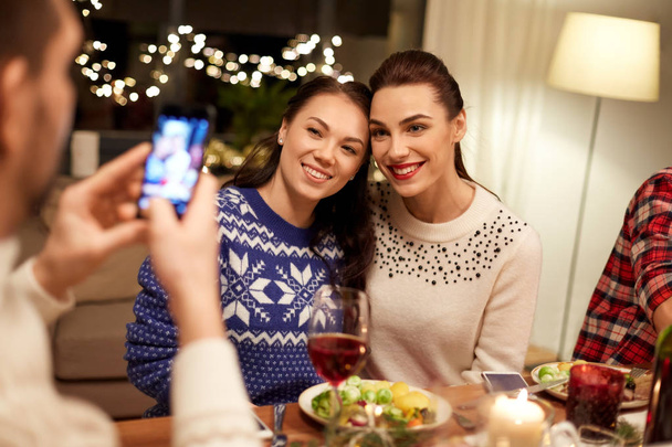 friends having christmas dinner and taking picture - Photo, Image