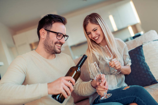 Young couple drinking wine at home.Romantic moments. - Foto, immagini