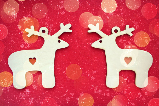 Two identical Christmas deer on textured red background.Free space for text. Christmas or new year cardn - Foto, imagen