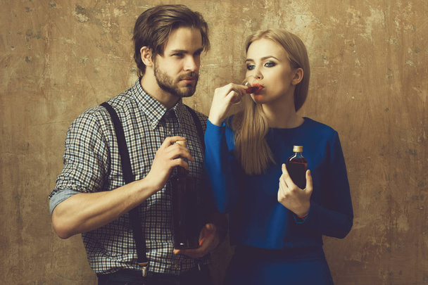 Girl drinking glass of liqueur with man - 写真・画像