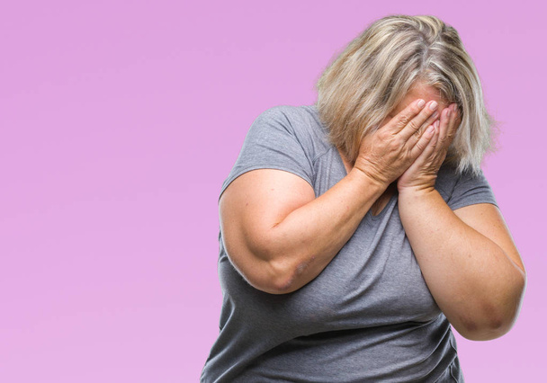 Senior plus size caucasian woman over isolated background with sad expression covering face with hands while crying. Depression concept. - Photo, Image