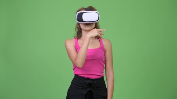 Studio shot of young beautiful nerd woman with curly blond hair wearing eyeglasses against chroma key with green background - Video