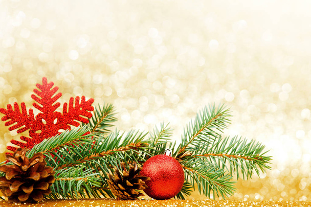 Christmas card with fir branch and decorations on golden gitter background - Foto, Imagem