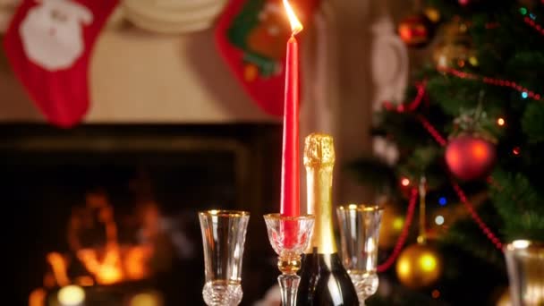Closeup 4k video of beautiful Christmas dinner with baked chicken and champagne in living room with burning fireplace and glowing Christmas tree - Video