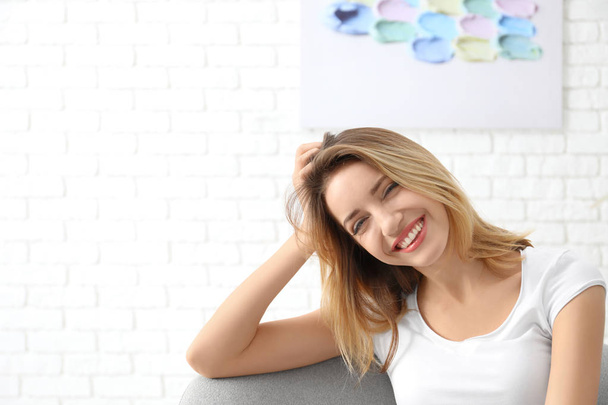 Portrait of beautiful smiling woman, indoors - Foto, imagen