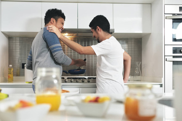 Homosexual Couple Eating Breakfast Cooking In Kitchen - Photo, Image